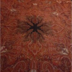 an orange and brown rug with a black center