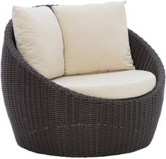 a gray wicker chair with two pillows on it's back and one white pillow