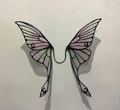 a paper cut out of a butterfly on a white background