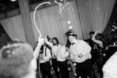 a group of people standing on top of a dance floor covered in confetti