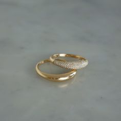 Bold is the way to go. Stacked or separate, these beautiful rings will do the talking for you.The Dome Duo Gift Set includes: The Gold Dome Ring: Keep it simple while making a statement in our 14k gold dome ring. The Diamond Dome Ring: With pavé diamonds and 14k gold, this dome ring takes style to new heights. $2,300 value which means you save 15% and a whole bunch of time since we did the styling for you. There’s something to be said about a solo moment, but we believe style should be stacked. Round Rings Gold, Dome Wedding Ring, Basic Gold Ring, Dome Gold Ring, Gold Stone Rings For Women, Cute Gold Rings Simple, Mix Metal Wedding Ring Stack, Simple Gold Ring Designs Unique, Simple Ring Designs Gold