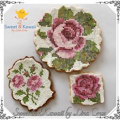 two small coasters with pink roses on them