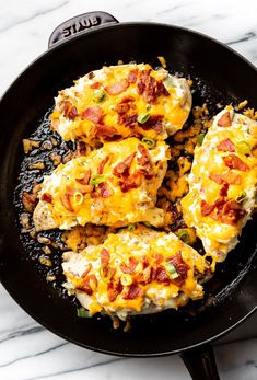 some food is cooking in a skillet on the stove top and ready to be eaten