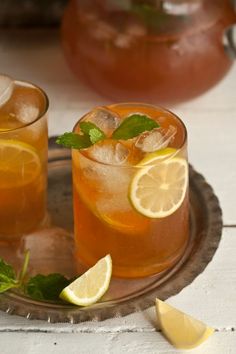 two glasses of iced tea with lemon and mint garnish on the rims