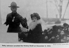 an old black and white photo of two women standing next to each other in front of a crowd