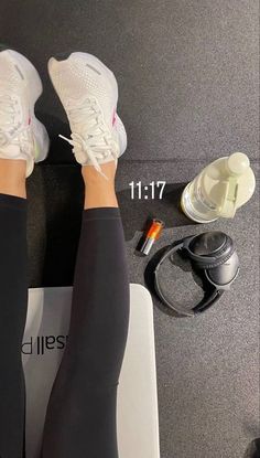 a woman's legs are shown with her feet on a weight scale and other sports equipment