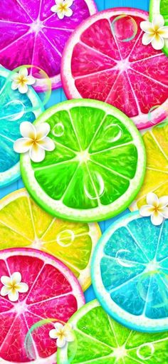 colorful slices of fruit are arranged on a blue and green background with white flowers in the center