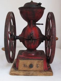 an old fashioned spinning wheel on a wooden deck