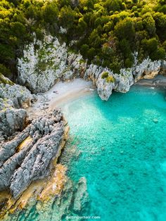 an aerial view of the blue lagoons and cliffs near split rock formations in croatia