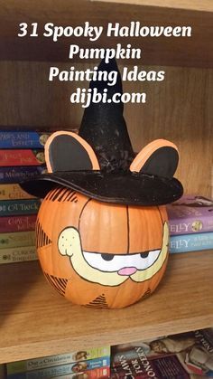 a pumpkin decorated with an image of a cat wearing a witch's hat on top of it