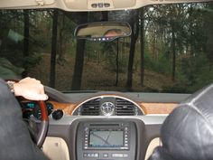 the interior of a car with trees in the background