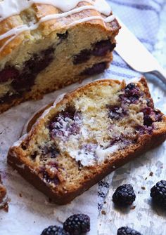 a piece of cake with icing and berries next to it