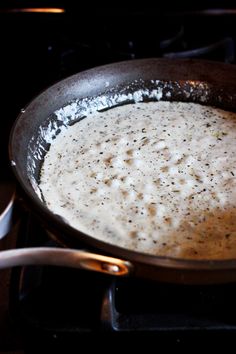 a pan filled with food sitting on top of a stove