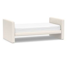 a white daybed sitting on top of a white floor