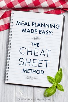 a notepad with the words meal planning made easy on it next to a red and white checkered napkin