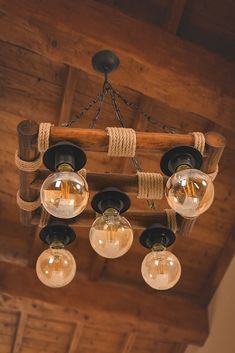 a chandelier made out of wood and glass globes hanging from the ceiling