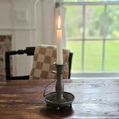 Add an antique touch to any tabletop with our Pewter Style Taper Chamberstick. This metal taper holder features a pewter look with its aged and distressed grey finish, giving this candle holder a timeworn feel. It has an embossed floral design on the tray, a long neck and a graceful handle. Bring Colonial period style to your farmhouse with this charming chamberstick. Candle not included Wire Wall Basket, Preserved Boxwood Wreath, Magnolia Leaf Wreath, Farmhouse Stools, Farm Fresh Milk, Wood Spool, Farmhouse Fabric, Taper Holders, Candle Ring