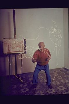 a man standing in front of a drawing on the wall