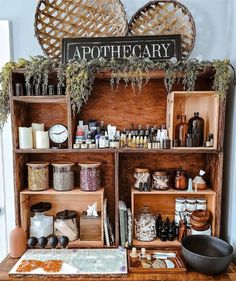 an old wooden cabinet filled with lots of bottles and jars on top of a table