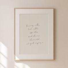 a white framed photograph hanging on the wall