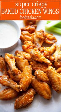 chicken wings on a plate with ranch dip and celery sticks in the background