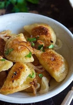 a white bowl filled with food on top of a table