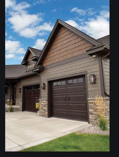 a large house with two garages on the front and one above it's door