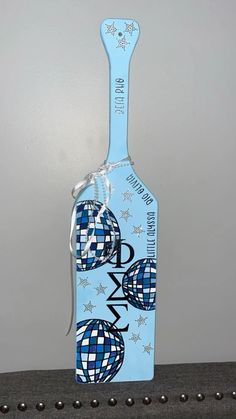 a bottle shaped like an airplane with blue and white designs on the top, sitting on a table