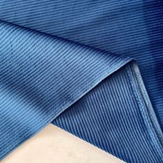 the blue fabric is folded on top of each other