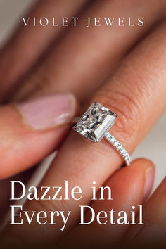 a close up of a person's hand with a diamond ring on their finger