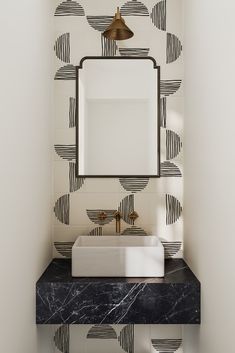 a bathroom with a sink, mirror and black and white wallpaper on the walls