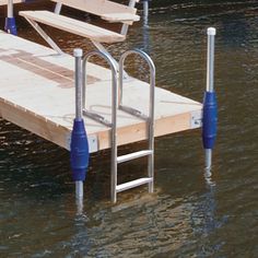 the dock is surrounded by water with benches and poles sticking out of it's sides