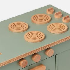 a toy stove top with wooden circles on it