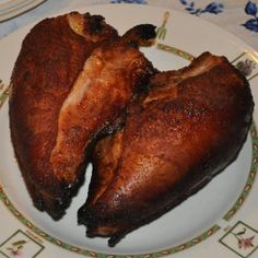 two pieces of cooked chicken on a plate