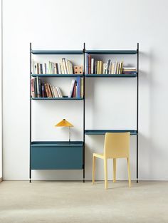 a yellow chair sitting in front of a bookshelf