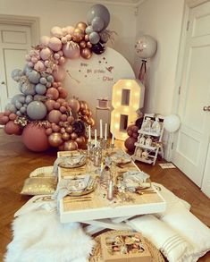 the table is set with silver and gold balloons