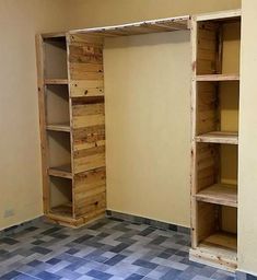 an empty room with wooden shelves and tiled floor