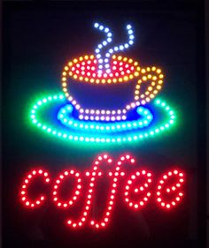 a neon sign that says cafe with a lit up coffee cup in the middle of it