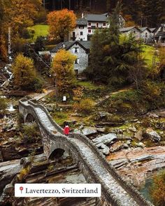 a person walking across a bridge over a river