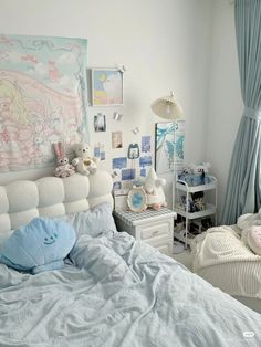 a child's bedroom with white walls and pastel blue drapes on the windows