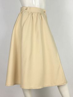 "60s swing skirt, wrap skirt, off white wrap midi skirt  mannequin measures 5ft 8\", bust 34\", waist 25\", hip 33\" Measurements:  waist 13\"/hip 23\"-open/length 28\"/width of bottom 40\" Please note that vintage clothing sizes can vary greatly.  The Measurements provided are taken with garment lying flat.  I suggest taking a similar garment from your wardrobe and measure it while lying flat.  This way you can compare measurements.   Please note buyer is responsible for any duties, taxes or customs clearance fees imposed by their country. Be sure to check in often as new gems are added daily.. **all sales are final." Beige Lined Maxi Skirt For Daywear, Relaxed Fit Cream Midi Maxi Skirt, Fitted Beige Maxi Skirt For Daywear, Relaxed Cream Midi Length Maxi Skirt, Cream Fitted Flared Maxi Skirt, Fitted Flared Cream Maxi Skirt, Cream Relaxed Midi Maxi Skirt, Fitted Cream Flared Maxi Skirt, Long Cream Skirt With Gathered Detail