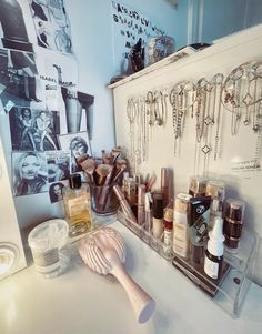 there are many different items on the counter in this room, including makeup and jewelry