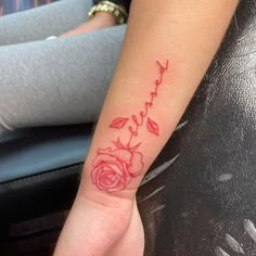 a woman's arm with a rose tattoo on it and the word love written in cursive writing