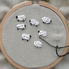 a close up of a embroidery with sheep on it