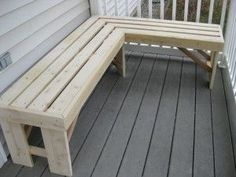 a wooden bench sitting on top of a porch