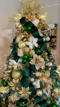 a christmas tree decorated with green and gold ornaments