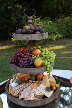 three tiered trays filled with fruit and crackers