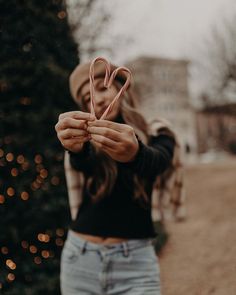 a woman holding up a pair of scissors in front of her face