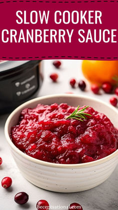 slow cooker cranberry sauce in a white bowl with fresh cranberries around it