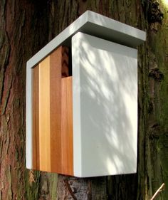 a bird house built into the side of a tree